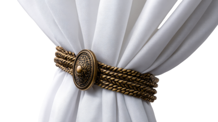 A close-up of a decorative curtain tieback, featuring a brass-colored, braided band with a decorative button.  White fabric drapes elegantly behind