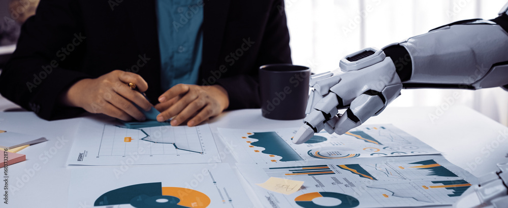 Poster a modern business meeting featuring a human and a robot discussing financial data. the collaborative