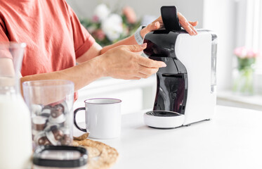 Close-Up Of A Woman Making Coffee In The Coffeemaker At Home