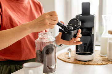 Woman Making Coffee In A Coffee Machine At Home, Close-Up
