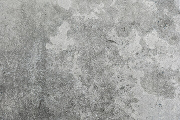 Superficie de concreto gris con textura rugosa y manchas de desgaste