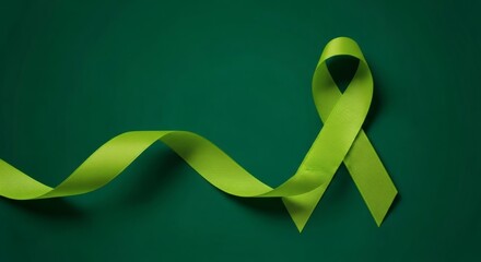 Green awareness ribbon symbolizing hope and support on a dark green background
