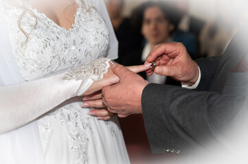 Bride and groom exchanging wedding rings