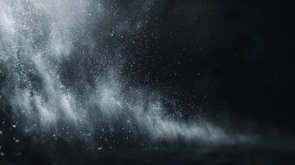Dynamic white dust particles illuminated by soft light against a dark dramatic matte black background creating an abstract and mysterious atmospheric