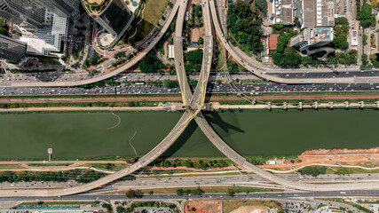 Top-down drone aerial view of Octávio Frias de Oliveira cable-stayed bridge in São Paulo Brazil with traffic, highways and Pinheiros River on a sunny day