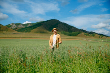 Naklejka premium Portrait young man farmer on background Altay field, sunlight. Concept Farm small business agricultural