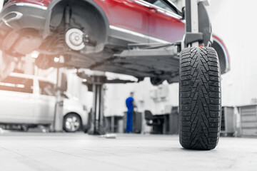 Concept maintenance of auto, background with sunlight. Car tires pile in garage service center or...