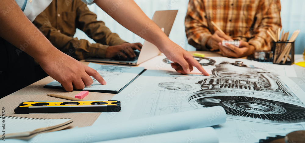 Poster a dynamic team collaborates in a bright office, surrounded by engineering plans and various tools. l