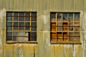 Corrugated wall and multi pane windows of Abandoned gas station garage, Death Valley Junction, California 