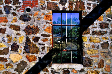 Shadow of roof beam and fieldstone wall of defunct old service station on old Route 66, Narcissa, Oklahoma