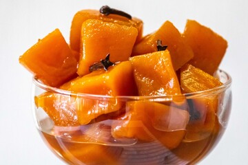 An ancient, vintage dessert known as pumpkin bricks in syrup, prepared with quicklime, cloves, and...
