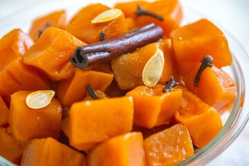 An ancient, vintage dessert known as pumpkin bricks in syrup, prepared with quicklime, cloves, and...
