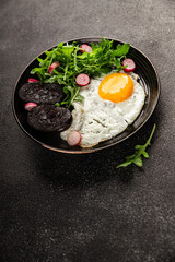 Eggs breakfast black pudding, egg, vegetables, arugula portion size natural product tasty snack fresh delicious gourmet food background on the table rustic top view copy space