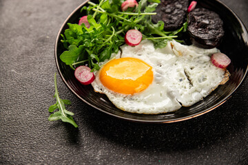 Eggs breakfast black pudding, egg, vegetables, arugula portion size natural product tasty snack fresh delicious gourmet food background on the table rustic top view copy space