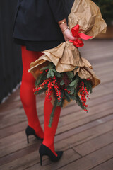 beautiful blond woman in Christmas style, girl is being prepared for the new year. walk at the street with  Christmas tree, smile, take photo