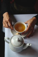cup of tea at the table with woman hands