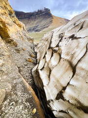 A close-up view captures the remaining glacier snow on top of the Siyeh Pass Trail
