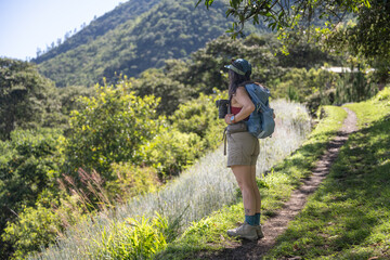 A hispanic woman hiking in the mountains