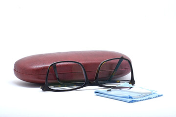 SIDE VIEW OF EYE GLASS AND BOX ON ISOLATED BACKGROUND WITH SELECTIVE FOCUS ON OBJECT.