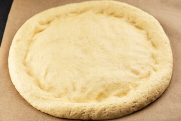 Raw pizza dough making pizza base tasty snack fresh delicious gourmet food background on the table rustic top view copy space