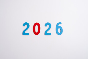 Colored numbers of the calendar for 2026 on the background. Happy New Year 2026 card.