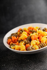 pasta trottole tricolor pasta spiral dish twisted Italian food tasty snack fresh delicious gourmet food background on the table rustic top view copy space  vegan and vegan food