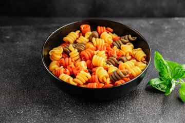 pasta trottole tricolor pasta spiral dish twisted Italian food tasty snack fresh delicious gourmet food background on the table rustic top view copy space  vegan and vegan food