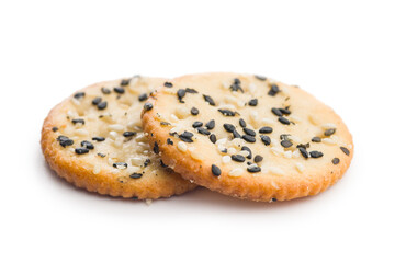 Crispy round salted crackers with sesame seeds isolated on white background.