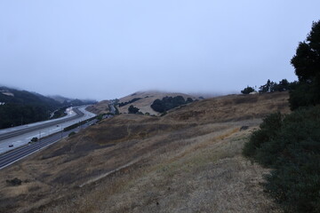 road in mountains with fog