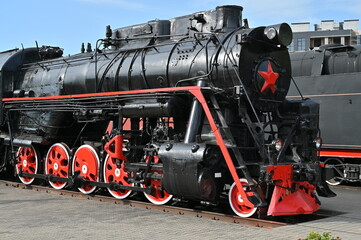 Black locomotive with red wheels - first half of the 20th century.