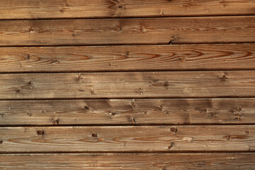 Fototapeta premium Neatly stacked light colored wooden planks in closeup. Smooth timber texture, natural grain pattern. Building material, interior design projects, background