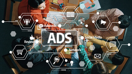 A diverse group of professionals collaborates on a marketing strategy in a modern workspace, utilizing digital tools to enhance advertising efforts and social media engagement. Amity