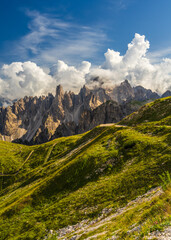 Alpine hiking trails cutting through rocky peaks of Dolomites with serene sky above. Captures...