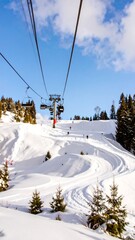 Ski lift ascends snowy mountain slope