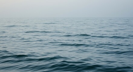 Obraz premium Calm Ocean Water with Mist and Foggy Horizon