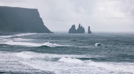 waves on black sand beach in southern Iceland at Vik seen from Dyrhólaey Lighthouse