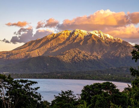 Mountain peak at sunrise over lake - Powered by Adobe