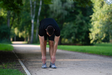 Fototapeta premium Man stretching in park