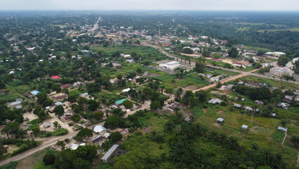 Aerial View of Rural African Town Nestled Amongst Lush Greenery and Overcast Sky republic of congo