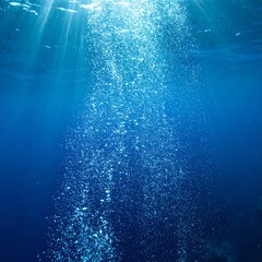 Underwater Bubbles Rising To the Surface in Deep Blue Ocean With Sun Rays