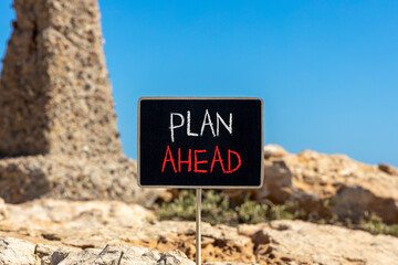 Plan ahead symbol. Concept word Plan ahead on beautiful black blackboard. Beautiful stone and blue...