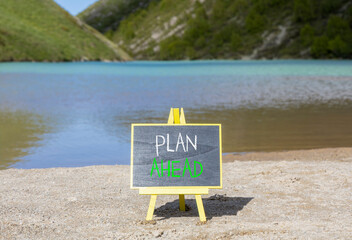 Plan ahead symbol. Concept word Plan ahead on beautiful black blackboard. Beautiful mountain lake...