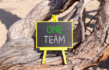 One team symbol. Concept word One team on beautiful black blackboard. Beautiful old tree...