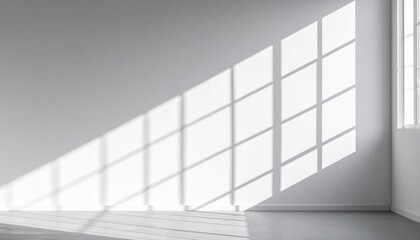 Fototapeta premium Bright Sunlight Casting Geometric Shadows on a White Wall in a Minimalist Room Interior