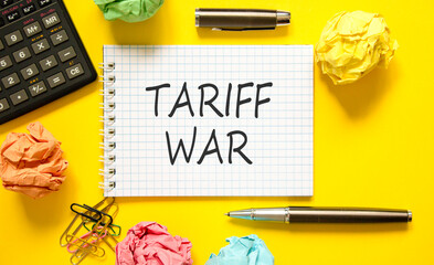 Trade tariff war symbol. Concept word Tariff war on beautiful white note. Black calculator. Black...