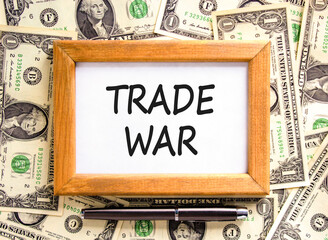Trade war symbol. Concept word Trade war on beautiful wooden picture frame. Dollar bills. Beautiful...