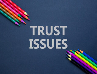 Trust issues symbol. Concept word Trust issues on beautiful black paper. Colored pencils. Beautiful...