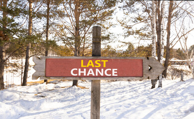 Last chance symbol. Concept word Last chance on beautiful wooden road sign. Beautiful snow winter...