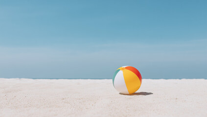 Obraz premium Beach Ball on Sand with Blue Sky