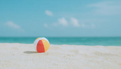 Obraz premium Beach Ball on Sand with Ocean Background